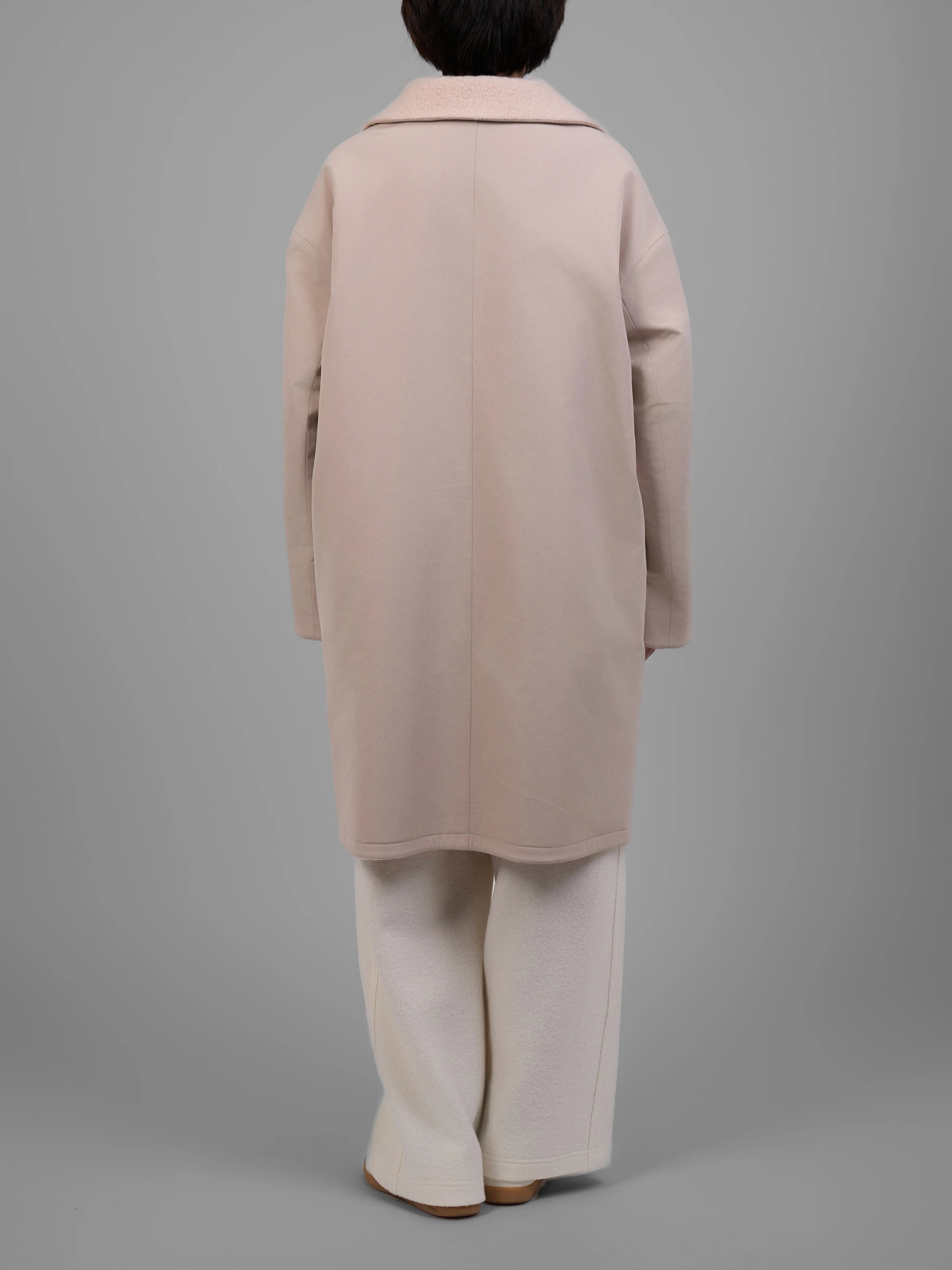 Full back view of reversible cream wool coat showing relaxed A-line drape.