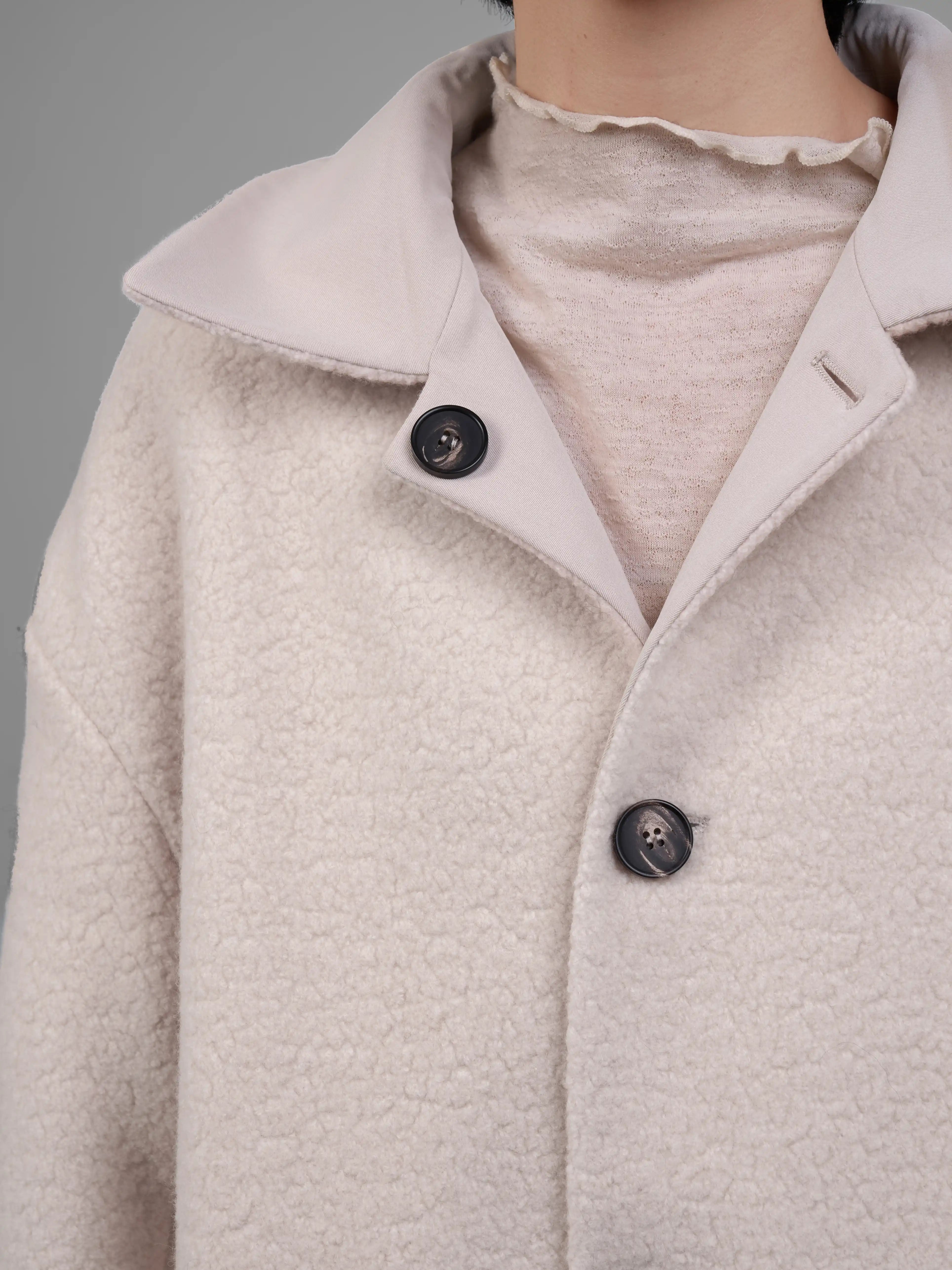 Fabric texture and button detail of XXLsmile cream reversible wool coat soft brushed wool surface