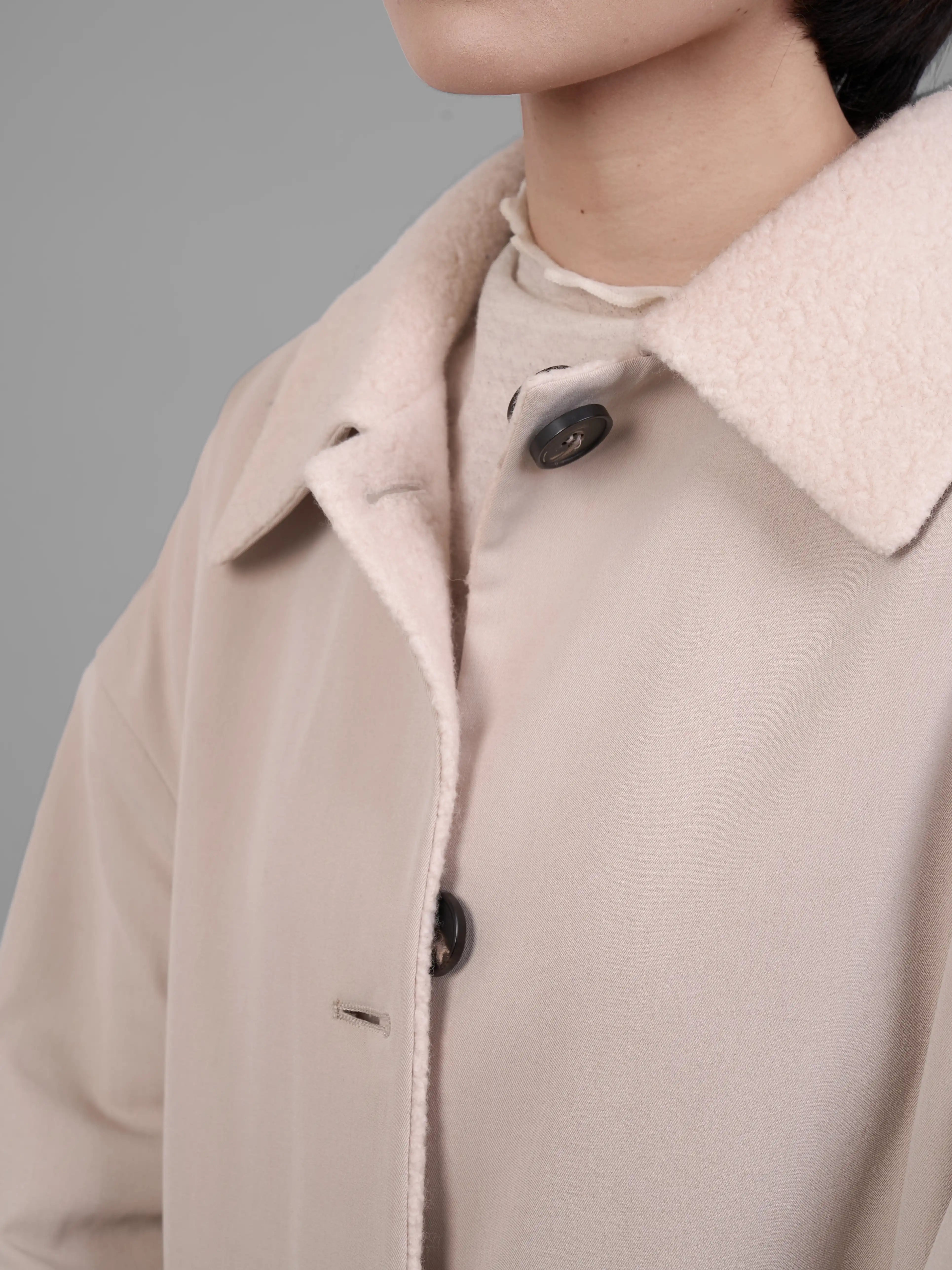 Close up collar detail of cream reversible wool coat by XXLsmile with structured lapel design