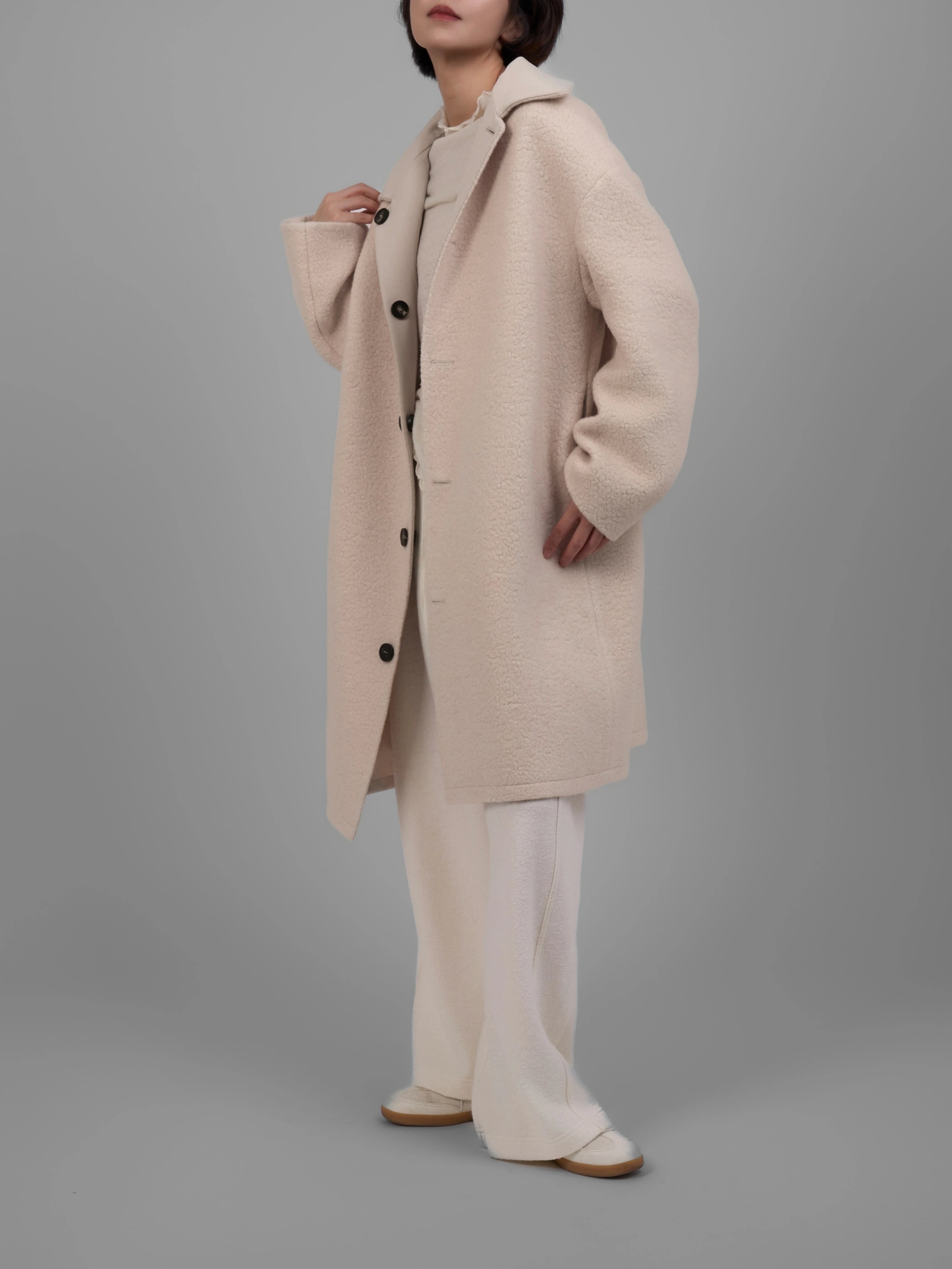 Reversible wool coat in cream, full-body front view showing relaxed silhouette and soft textured fabric.
