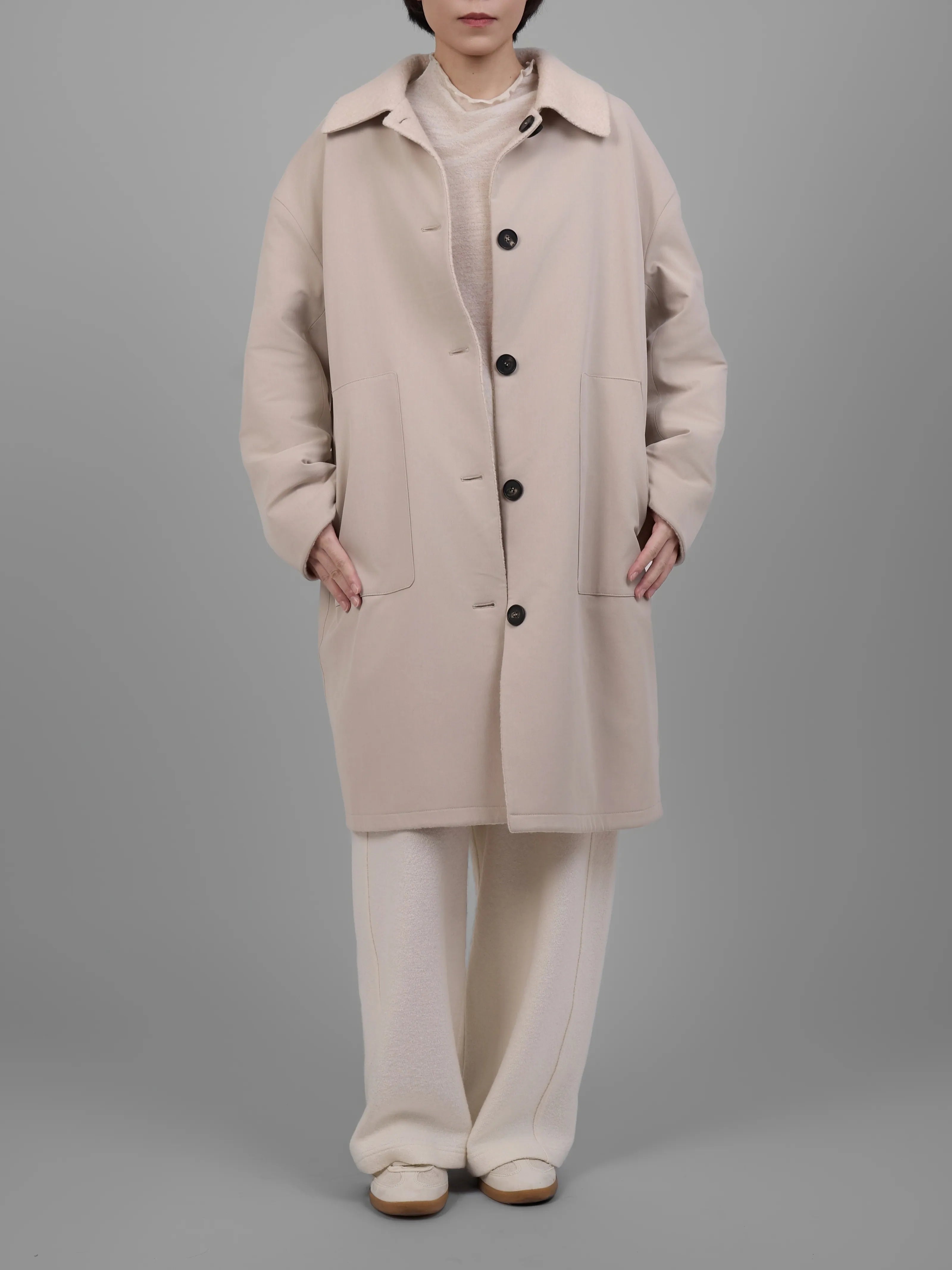 Front standing view of cream reversible wool coat by XXLsmile with minimalist oversized shape