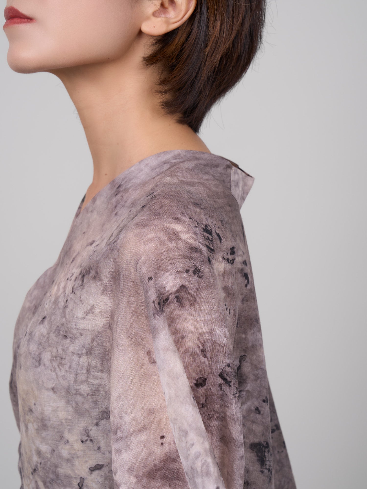 Close-up neckline and shoulder view of Tang Ramie Flowing Dress, textured ramie surface and lightweight drape.