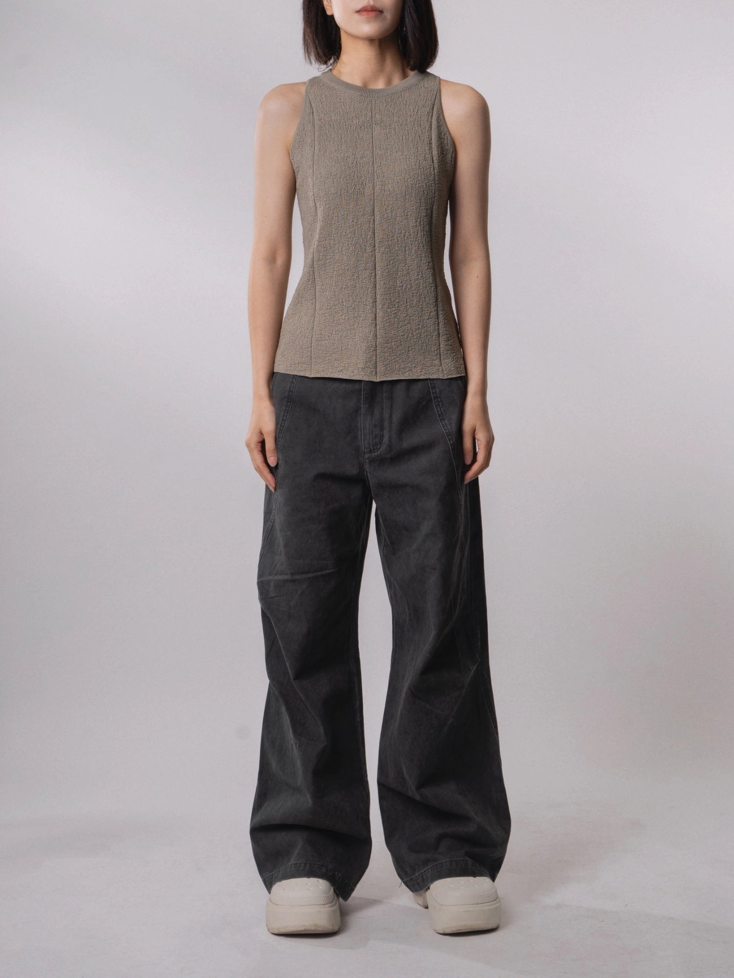 Front view of the Textured Knit Shell in Muted Sage paired with relaxed wide-leg trousers.