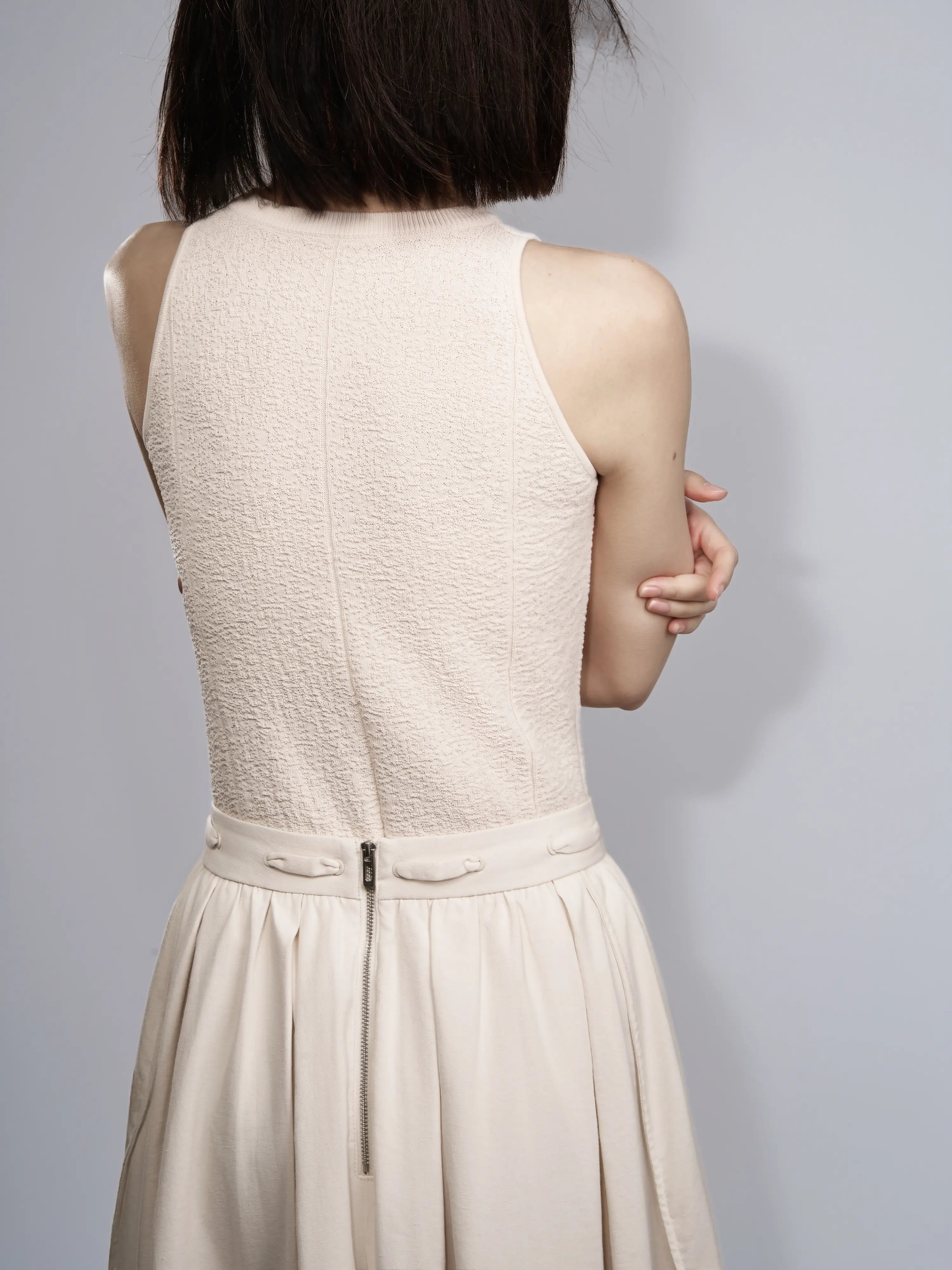 Back view of the Textured Knit Shell in Soft Cream showing the sleeveless silhouette.