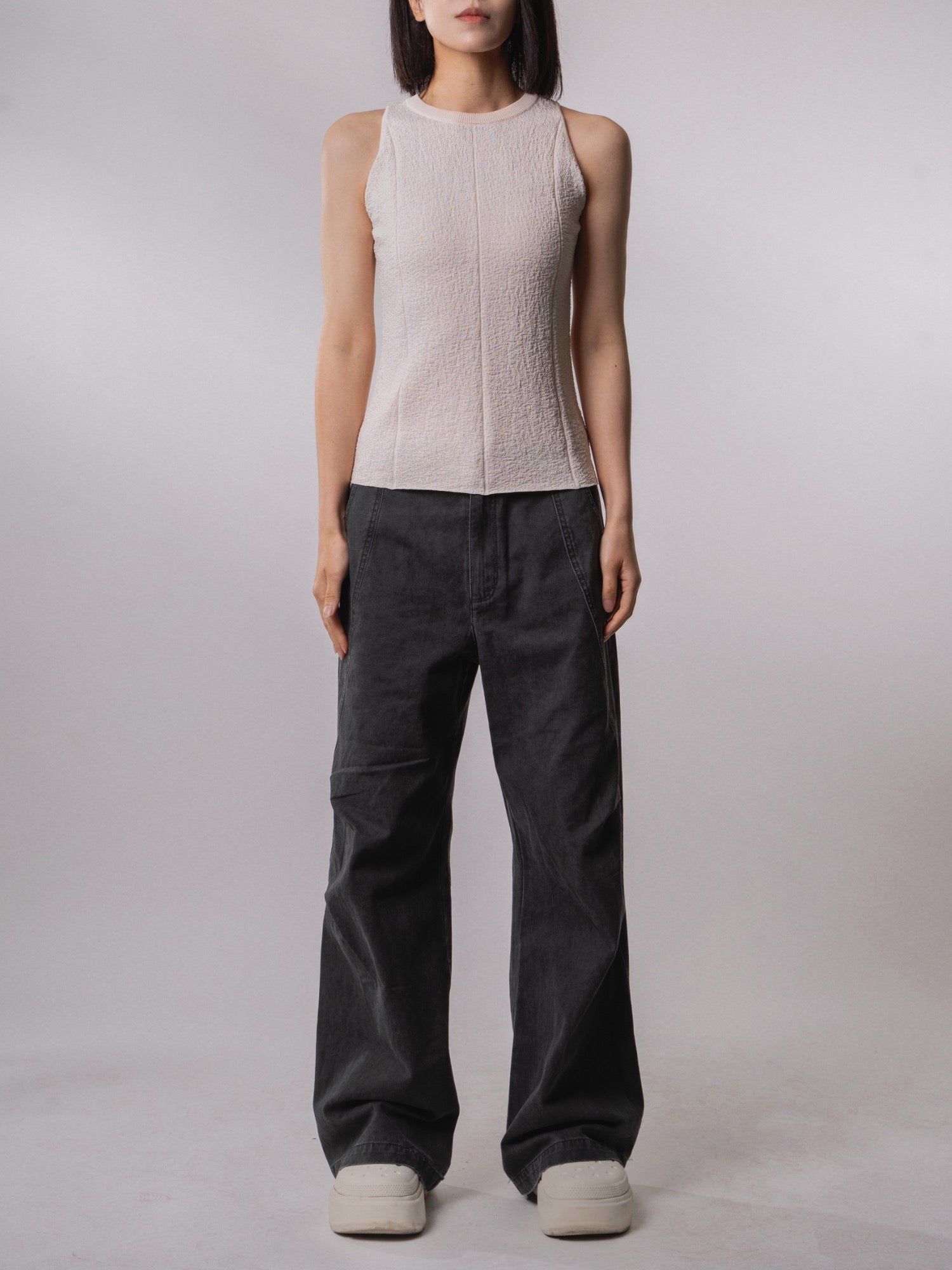Front view of the Textured Knit Shell in Soft Cream with relaxed wide-leg trousers.