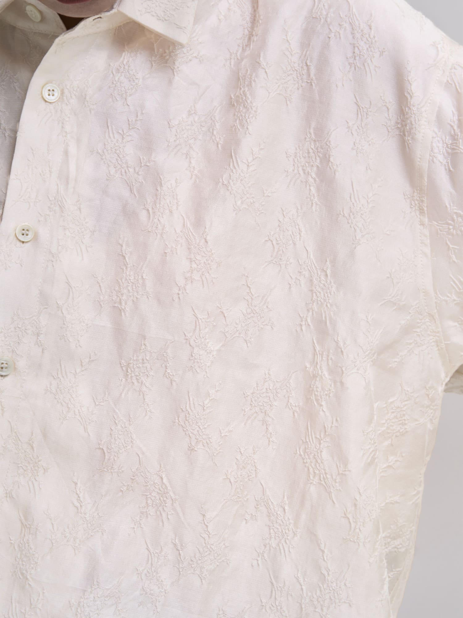 Close-up of white Textured Shirt fabric, highlighting fine texture, soft lyocell–cotton blend and clean tailoring.