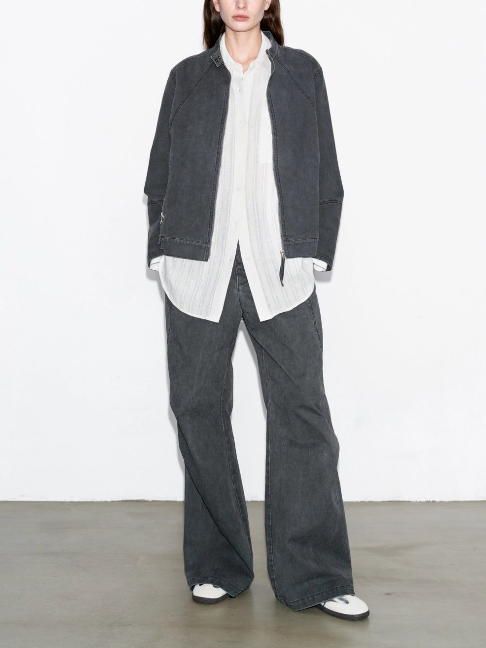 Model wearing charcoal washed paratrooper jeans with full outfit front view, relaxed straight silhouette, urban styling.