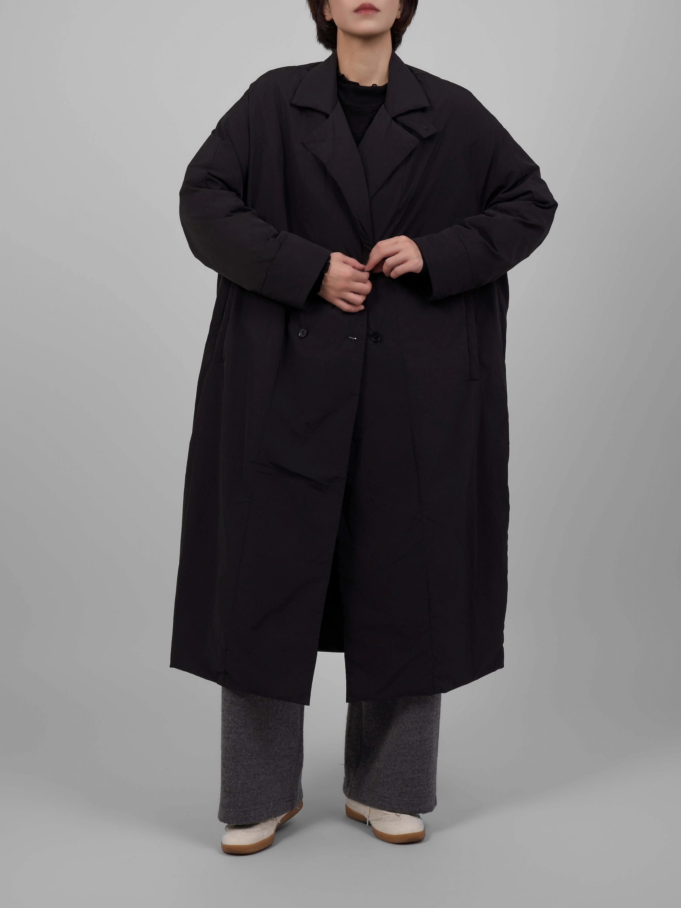 Full-body front view of black oversized down coat with relaxed stance.